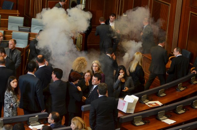 Kosovo MPs are seen in parliament during a session where opposition lawmakers fired tear gas and pepper spray in the captial Pristina November 17, 2015. Opposition lawmakers in Kosovo fired tear gas and pepper spray in parliament on Tuesday and police clashed with rock-throwing protesters in a deepening political crisis over relations with former master Serbia. The opposition is demanding the government scrap a European Union-brokered deal to regulate ties between Serbia and Kosovo, its former southern province, which declared independence in 2008. REUTERS/Hazir Reka      TPX IMAGES OF THE DAY
