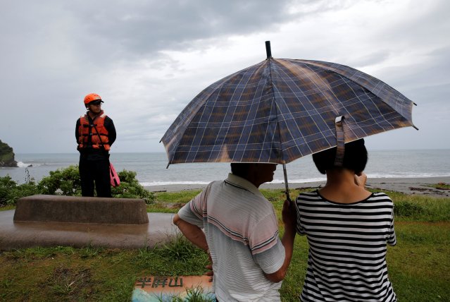 A coast guard stands guard at the coast as Typhoon Malakas approaches in Yilan, Taiwan September 17, 2016. REUTERS/Tyrone Siu     TPX IMAGES OF THE DAY