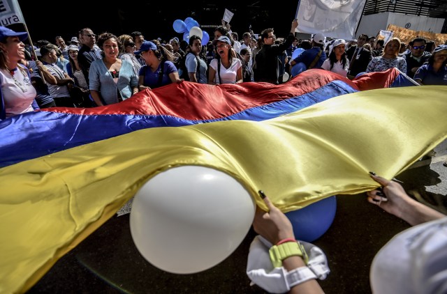 General Prosecutor's office employees demonstrate in support of Attorney General Luisa Ortega in Caracas on June 19 , 2017.   Venezuela's Supreme Court on Friday rejected a bid to put on trial several senior judges accused of favoring embattled President Nicolas Maduro as he clings to power in the face of deadly unrest. / AFP PHOTO / JUAN BARRETO