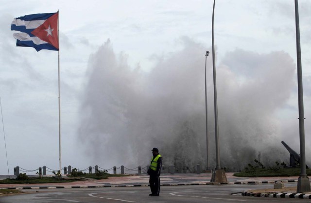 A police officer stands on the seafront boulevard El Malecon ahead of the passing of Hurricane Irma, in Havana, Cuba September 9, 2017. REUTERS/Stringer NO SALES. NO ARCHIVES TPX IMAGES OF THE DAY