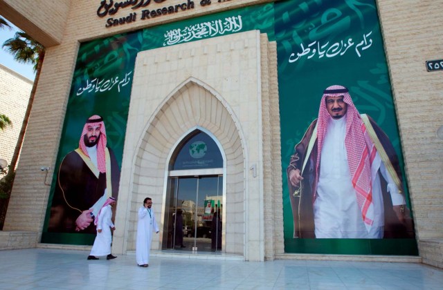 Men walk past posters depicting of Saudi Arabia's King Salman bin Abdulaziz Al Saud and Crown Prince Mohammed bin Salman in Riyadh, Saudi Arabia, November 9, 2017. REUTERS/Faisal Al Nasser NO RESALES. NO ARCHIVE.