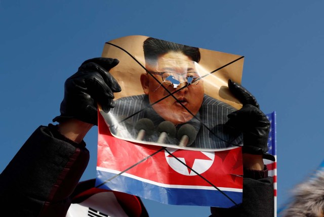 A demonstrator holds a defaced portrait of North Korean leader Kim Jong Un during an anti-North Korea protest before the opening ceremony for the Pyeongchang 2018 Winter Olympics in Pyeongchang, South Korea, February 9, 2018. REUTERS/Edgar Su