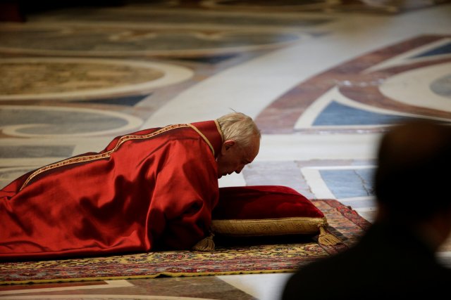 Pope Francis lies on the floor during the Good Friday Passion of the Lord Mass in Saint Peter's Basilica at the Vatican, March 30, 2018. REUTERS/Max Rossi