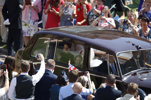 Page boys John and Brian Mulroney accompany US actress Meghan Markle as she arrives in a car for the wedding ceremony to marry Britain's Prince Harry, Duke of Sussex, at St George's Chapel, Windsor Castle, in Windsor, Britain, May 19, 2018. Odd ANDERSEN/Pool via REUTERS