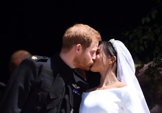 Britain's Prince Harry (L), Duke of Sussex and Meghan (R), Duchess of Sussex kiss as they exit St George's Chapel in Windsor Castle after their royal wedding ceremony, in Windsor, Britain, 19 May 2018. The couple have been bestowed the royal titles of Duke and Duchess of Sussex on them by the British monarch. NEIL HALL/Pool via REUTERS
