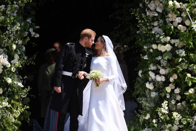 Britain's Prince Harry (L), Duke of Sussex and Meghan (R), Duchess of Sussex exit St George's Chapel in Windsor Castle after their royal wedding ceremony, in Windsor, Britain, 19 May 2018. The couple have been bestowed the royal titles of Duke and Duchess of Sussex on them by the British monarch. NEIL HALL/Pool via REUTERS